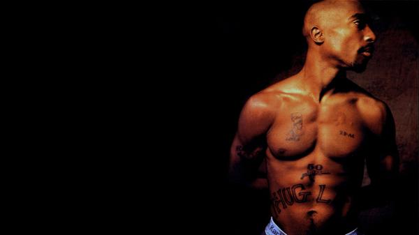 Free 2pac tupac is having tattoos on chest and abdomen facing one side hd music wallpaper download