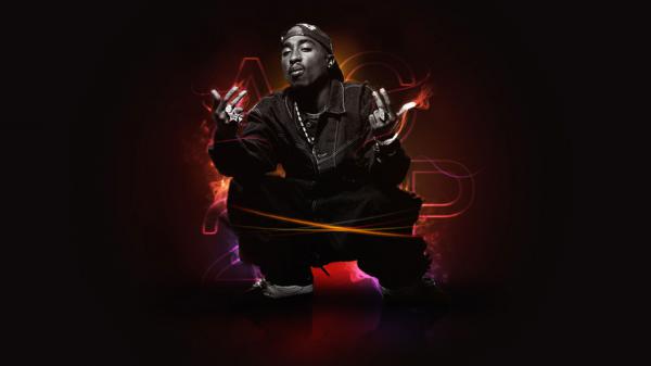 Free 2pac tupac is sitting on floor wearing black coat and cap having two fingers in the air hd music wallpaper download