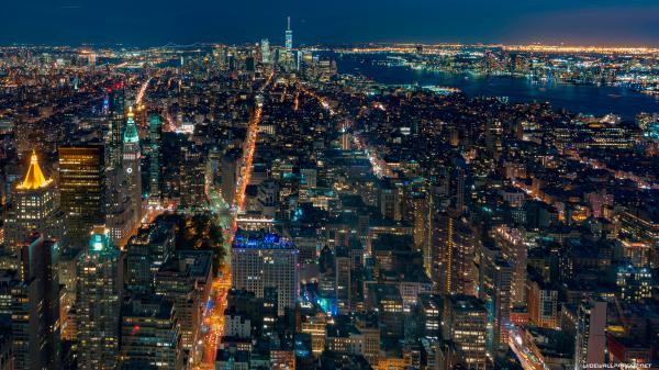 Free aerial view of new york city with shimmering lights during nighttime 4k hd travel wallpaper download