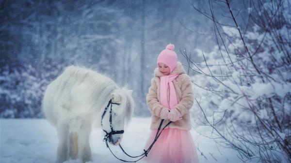 Free baby girl is wearing pink dress and woolen knit cap sweater holding rope of horse hd cute wallpaper download