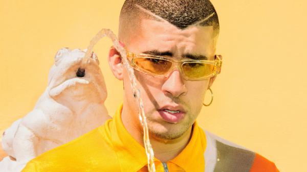Free bad bunny aesthetic in yellow background wearing yellow dress and sunglases with water spitting frog backside hd music wallpaper download
