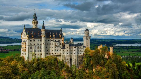 Free bavarian alps castle germany neuschwanstein under dark cloudy sky hd travel wallpaper download