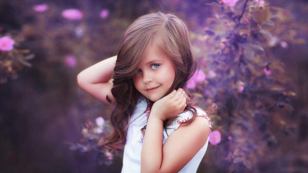 Free beautiful girl is giving a pose for photo wearing white dress in blur flowers background hd cute wallpaper download