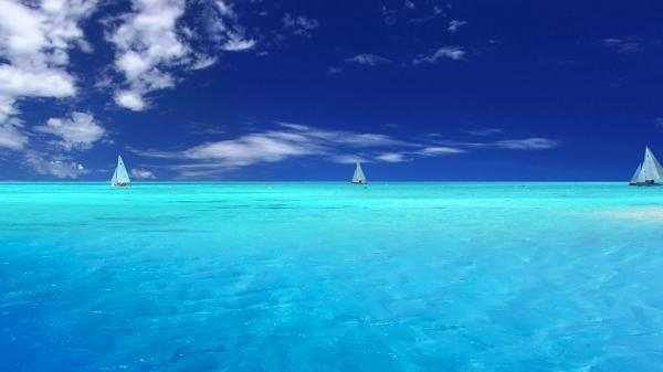 free boat on calm body of water under blue sky hd beach wallpaper download