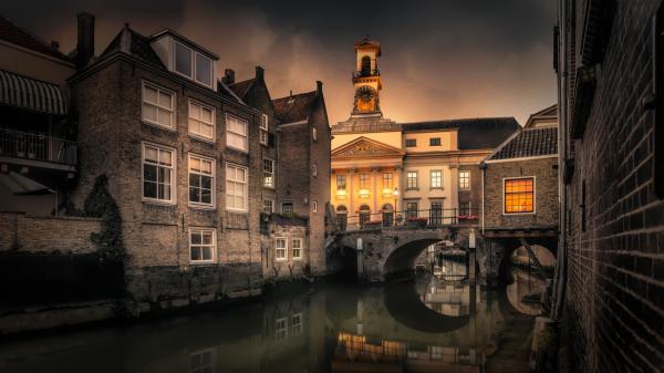 Free bridge between building and canal during evening time in netherlands hd travel wallpaper download