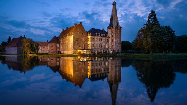 Free castle with reflection on calm body of water in germany during nighttime hd travel wallpaper download