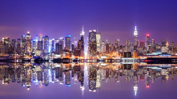 Free cityscape buildings with glittering lights reflection on river water under purple sky 4k 5k hd new york wallpaper download