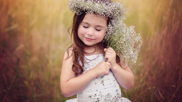 Free closed eyes cute little girl is wearing white dress and having wreath on head in green dry grass background hd wallpaper download