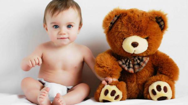 Free cute baby boy is sitting with brown toy teddy in white background hd cute wallpaper download