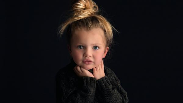 Free cute baby girl in black background is wearing black knit sweater 4k hd cute wallpaper download