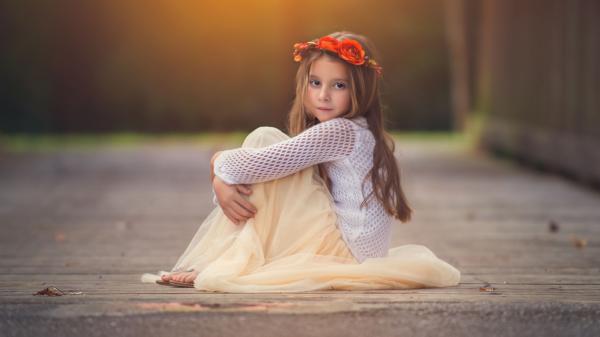 Free cute baby girl is sitting on road with hands on knees wearing sandal skirt and white netted top having flower crown on head in blur background hd cute wallpaper download