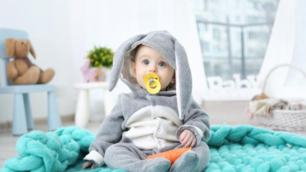 Free cute baby is sitting on blue color woolen mat having pacifier in mouth 4k 5k hd cute wallpaper download