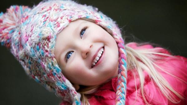 Free cute little girl is looking up wearing red dress and colorful wool knitted cap in black background hd cute wallpaper download