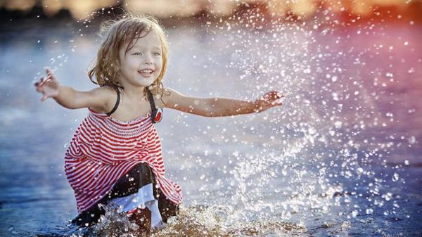 Free cute little girl is playing on body of water during daytime wearing red and white striped dress hd cute wallpaper download