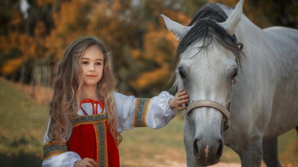 Free cute little girl is touching white horse wearing white red dress in blur background hd cute wallpaper download