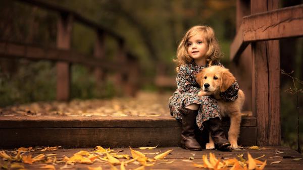 Free cute little girl with golden retriever cub wallpaper download