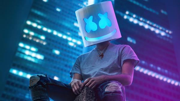 Free dj marshmello is sitting on roof top in building background 4k hd marshmello wallpaper download