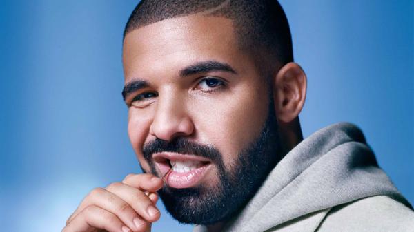 Free drake is inserting gold toothpick in mouth in blue background hd drake wallpaper download