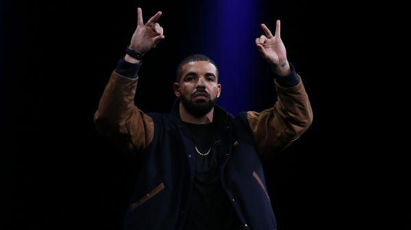 Free drake is showing hand sign wearing brown black overcoat in black background hd drake wallpaper download