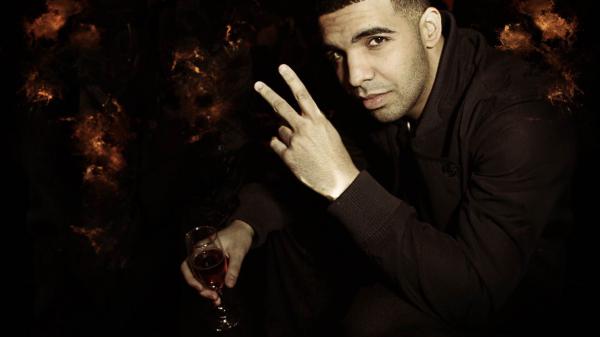 Free drake is showing victory sign and having glass in hand wearing black dress hd drake wallpaper download