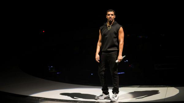 Free drake is standing on stage with shadow wearing black dress and having mike in hand hd drake wallpaper download