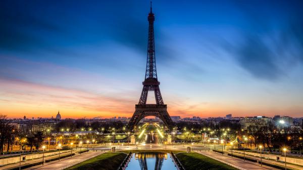 Free eiffel tower with shimmering lights in front with shallow background of sky during evening time hd travel wallpaper download