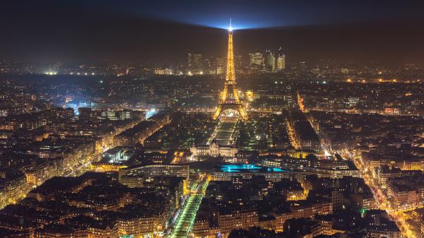 Free eiffel tower with yellow lights and blue light on top and city with shimmering lights with dark sky background hd travel wallpaper download