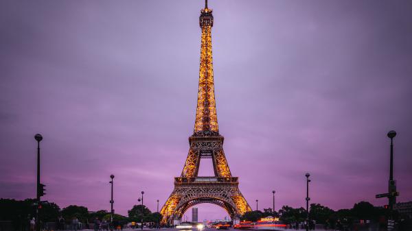 Free eiffel tower with yellow lights with purple sky background hd travel wallpaper download