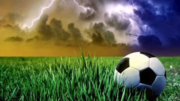 Free football on green grass in lightning sky background hd football wallpaper download