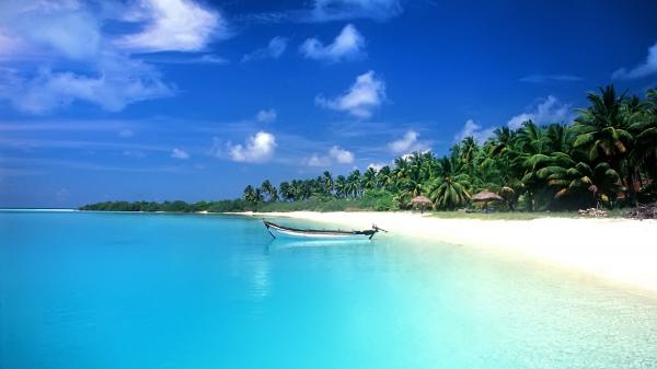 free hut on beach sand and white boat on body of water under blue sky hd beach wallpaper download