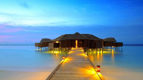 free huts in the middle of body of water with lightning wooden dock hd beach wallpaper download