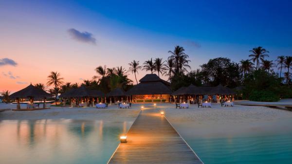 free huts with tables in front of sea during evening time with dock near sand hd beach wallpaper download