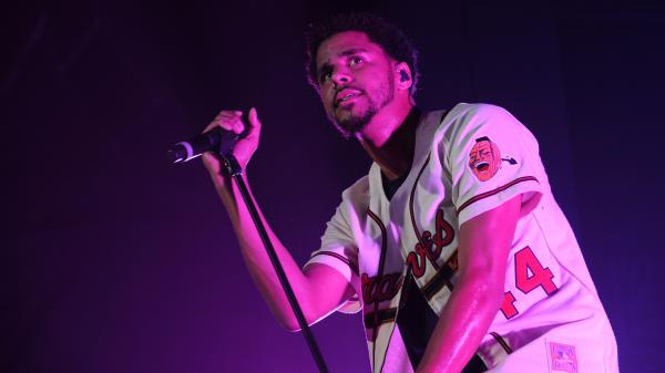 Free j cole is looking up holding mike wearing white t shirt in purple background hd music wallpaper download