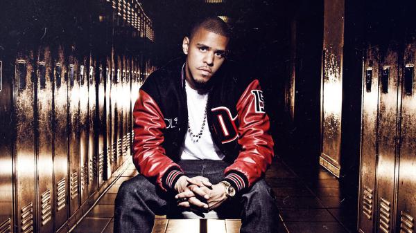 Free j cole is sitting on chair wearing white t shirt and red black overcoat hd music wallpaper download