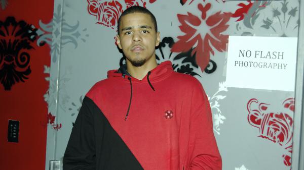 Free j cole is standing in front of glass wearing red black t shirt hd music wallpaper download