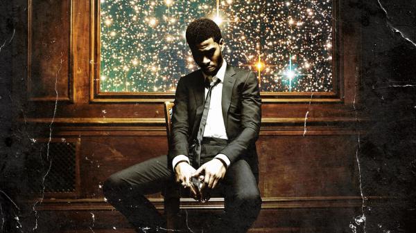 Free kid cudi is sitting on chair looking down holding glass in hands wearing white black coat suit hd kid cudi wallpaper download