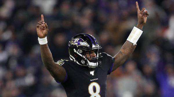 Free lamar jackson is wearing black sports dress and helmet with hands in the air in a blur audience background 4k 5k hd sports wallpaper download