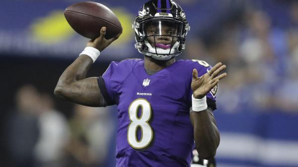Free lamar jackson with sprint football and wearing white bands in hands and purple sports dress and black helmet hd sports wallpaper download