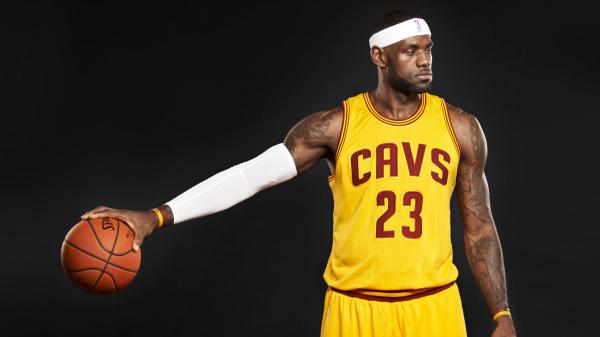 Free lebron james is having basketball in one hand facing one side in a black background wearing yellow sports dress hd sports wallpaper download