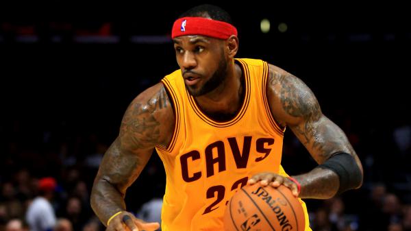 Free lebron james is tapping basketball wearing yellow sports dress and red band on head in a black background hd sports wallpaper download