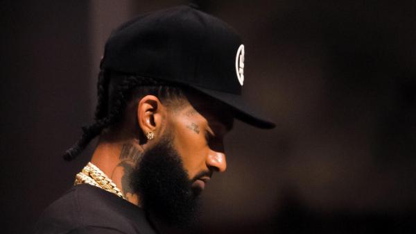 Free nipsey hussle is wearing black cap and chains on neck having beard hd music wallpaper download