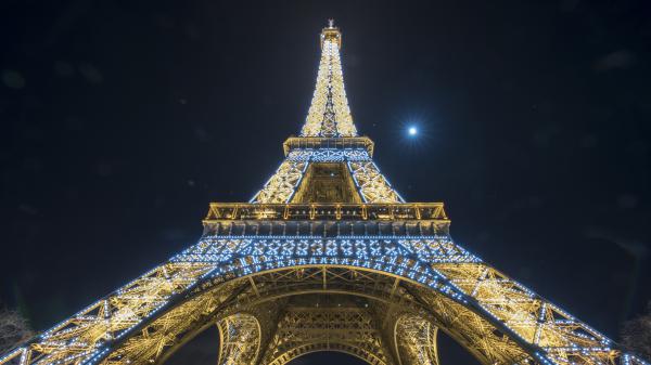 Free paris eiffel tower decorated with yellow and blue lights with background of dark sky with moon 4k 5k hd travel wallpaper download