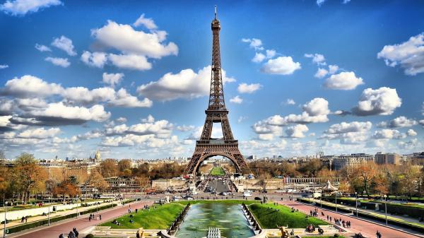 Free paris eiffel tower with background of blue sky and patches of clouds hd travel wallpaper download