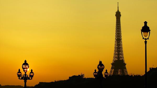 Free paris eiffel tower with background of yellow sky during evening hd travel wallpaper download