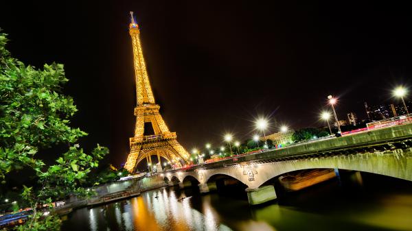 Free paris eiffel tower with yellow lights and bridge with glittering lights with background of black sky hd travel wallpaper download