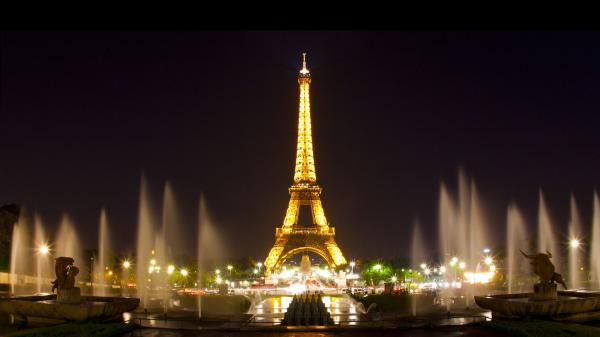 Free paris eiffel tower with yellow lights and water fountain with background of black sky during night time hd travel wallpaper download