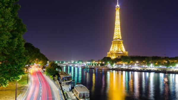 Free paris eiffel tower with yellow lights lake with boats and road on side with background of sky 4k hd travel wallpaper download