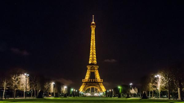 Free paris eiffel tower with yellow lights with dark sky background during night time hd travel wallpaper download