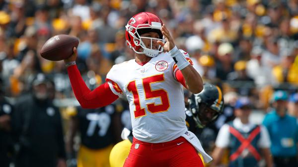Free patrick mahomes is trying to throw a sprint football wearing red and white sports dress and helmet in blur audience background hd sports hd (1) wallpaper download