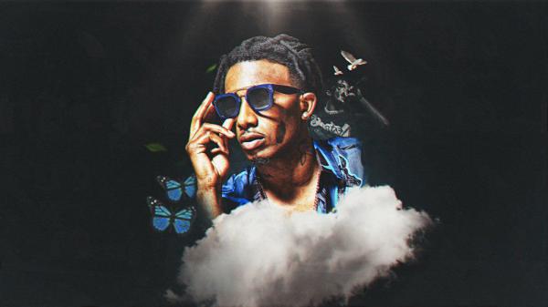 Free playboi carti is holding goggles with hand in black background wearing blue printed shirt hd music wallpaper download